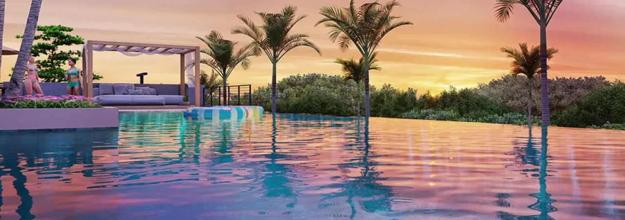 Piscina infinita com água cristalina refletindo as cores do pôr do sol, rodeada por palmeiras e vegetação tropical, com espreguiçadeiras e pessoas ao fundo em um ambiente de lazer sofisticado.